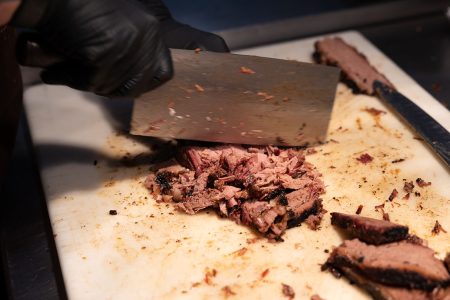 Brisket being chopped with a hatchet
